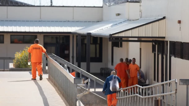 Prisoners move in a common area of the Joseph Harp Correctional Facility on Oct. 10, 2024.