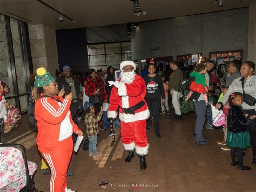 Santa waves in a room full of people