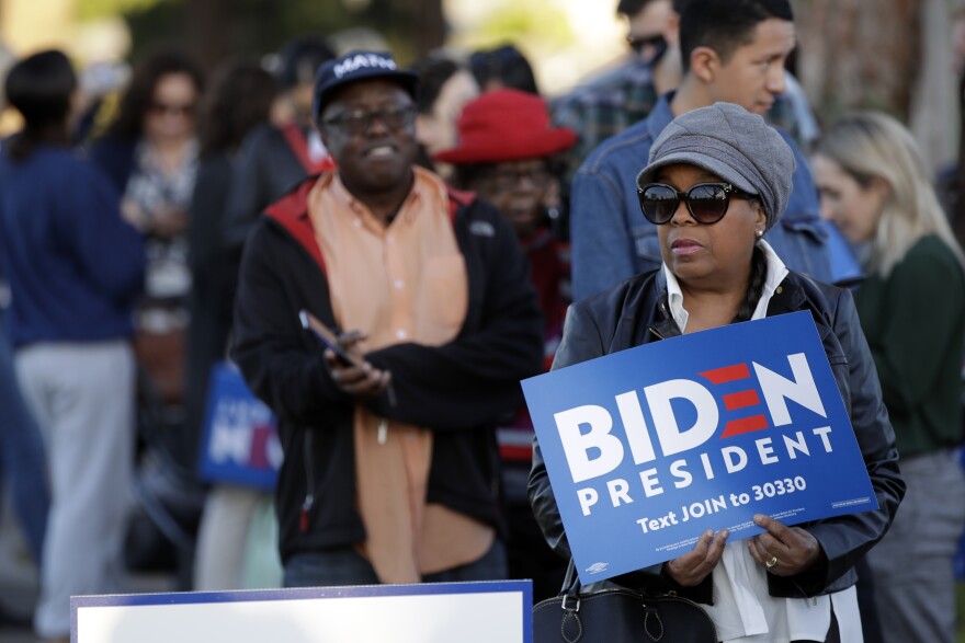 Black voters holding Biden for President signs wait to attend a campaign rally for Democratic presidential candidate former Vice President Joe Biden on Tuesday, March 3, 2020, in Los Angeles.