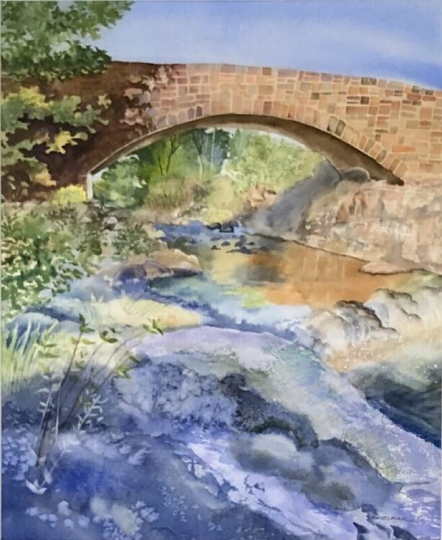 Watercolor painting of an old stone bridge over a river