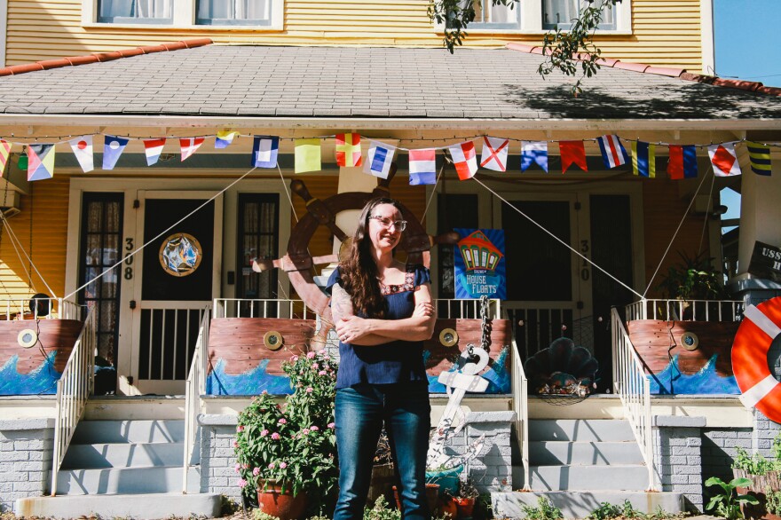 Megan Boudreaux, founder of Krewe of House Floats, stands outside her own home and the 'USS House Float,' in Algiers Point. "It's a little surreal how we got to this place," Boudreaux said.