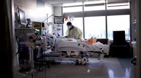 Respiratory Therapist Nirali Patel works with a COVID-19 patient in the ICU at Rush University Medial Center on Jan. 31, 2022, in Chicago, Illinois. (Scott Olson/Getty Images)