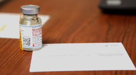 A vial of Moderna's coronavirus vaccine at a Bloomington vaccination site.