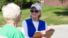 Democrat Pam Hickman talks with a voter while campaigning in a northeastside neighborhood.
