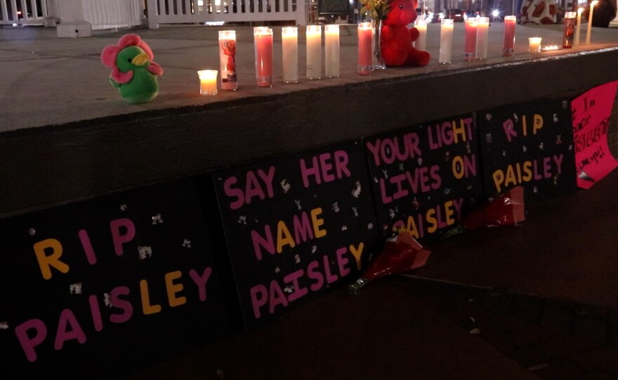 Signs, candles and stuffed animals are left in memory of Paisley Brown at a vigil in Ocala.