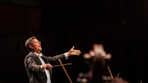 Man conducts on stage 