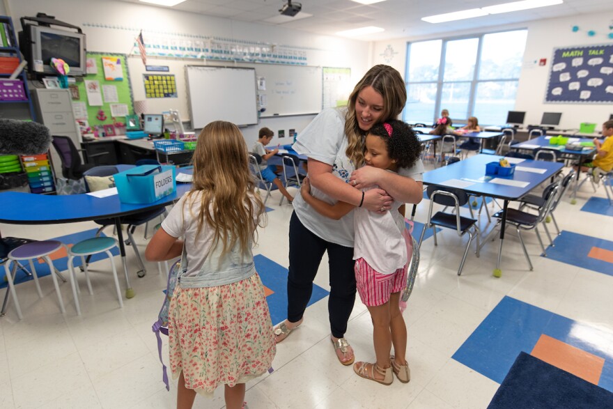 Edwin A. Anderson Elementary School 2nd grade teacher Jenna Parker hugs student Avery Smith, 7, on the first day back to school after Hurricane Florence made landfall in Wilmington. 