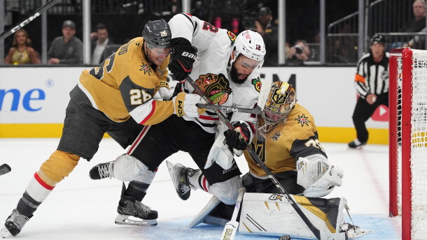Chicago Blackhawks' Jordan Greenway (12) falls into Vegas Golden Knights goaltender Carter Hart (79) during the first period of an NHL hockey game Tuesday, Sept. 29, 2026, in Las Vegas. (AP Photo/John Locher)