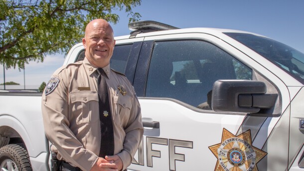 Weber County Sheriff Ryan Arbon stands next to a patrol vehicle outside the sheriff's office in Ogden, Aug. 25, 2026