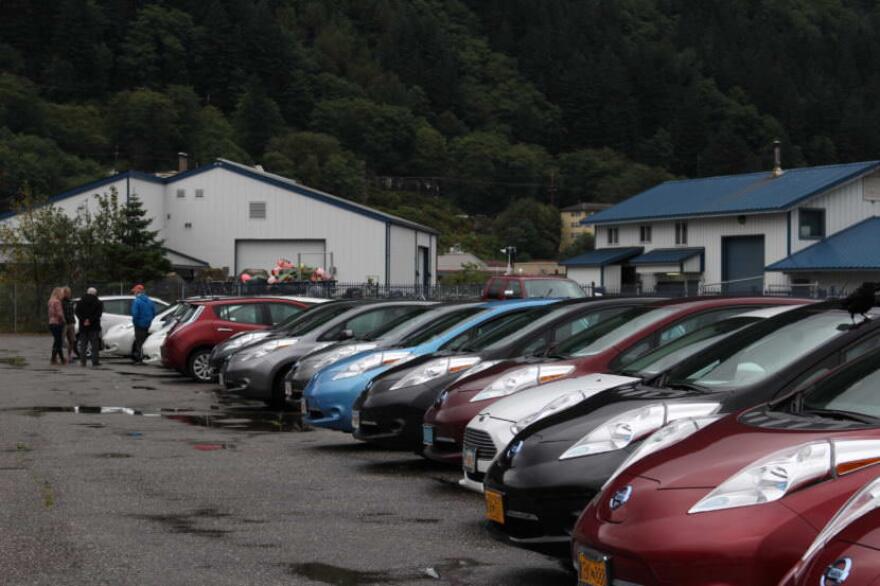 A line of vehicles in a parking lot