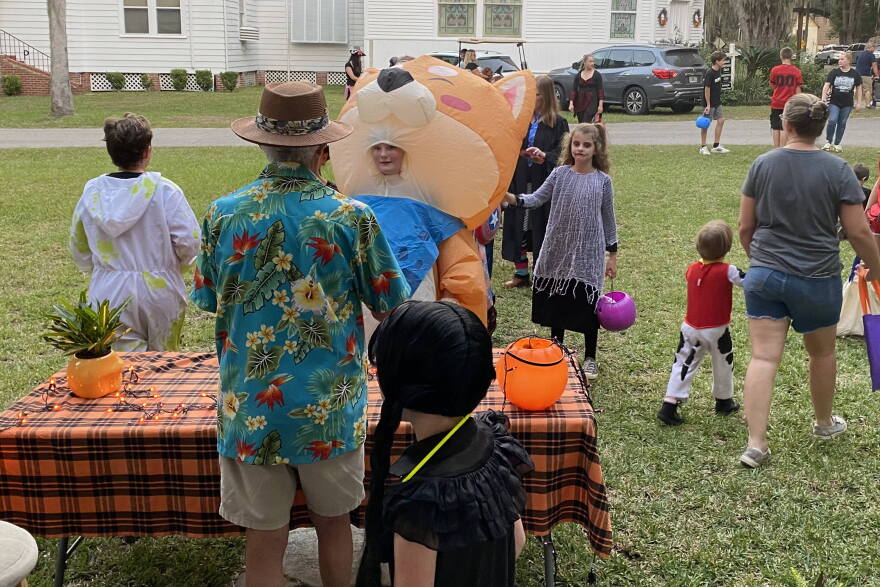Former McIntosh town councilman Frank Ciotti hands out candy to children outside his home. “I’m still a kid at heart,” Ciotti said. (Courtesy of Frank Ciotti)