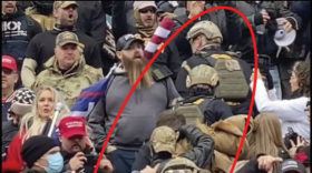 FBI officials say members of the Oath Keepers used a stack or line formation while climbing the steps to the Capitol on Jan. 6.  In this image from a criminal complaint, the red oval encircling the Oath Keepers was added by the FBI.