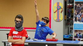 A student wearing a mask in the classroom
