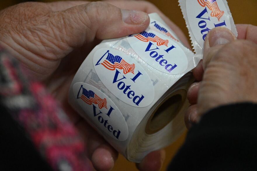  Election workers unrolling "I Voted" stickers at Northland Cathedral in North Kansas City, Missouri, on Aug. 2, 2022.