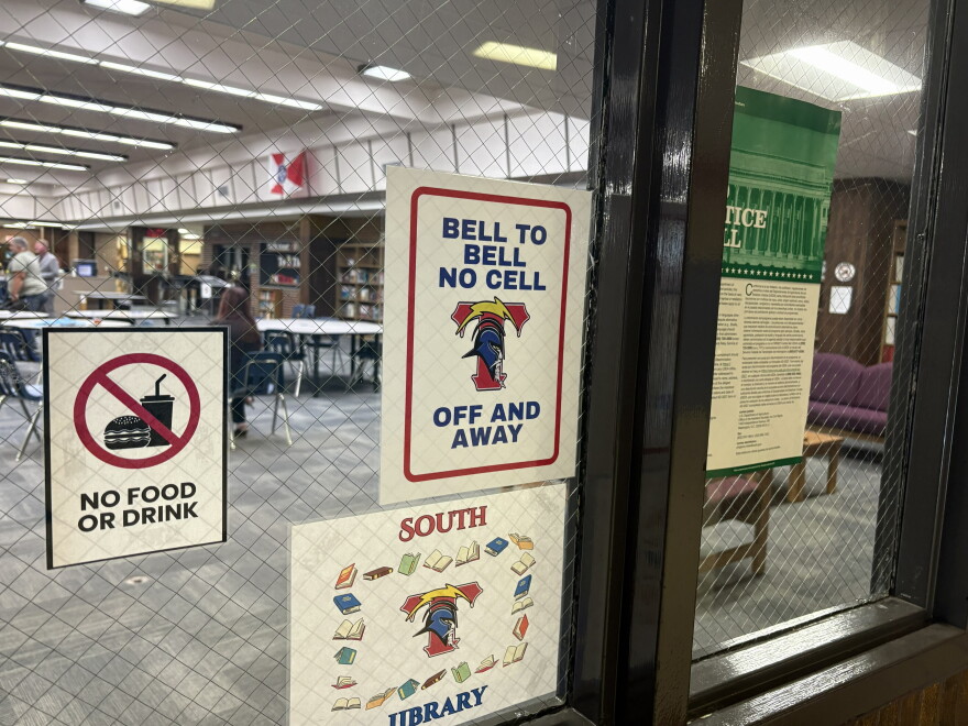 A sign posted on the door of the library at Wichita South High School advises students not to use their phones. In the spring, Kansas lawmakers banned student cell phone use at K-12 schools in the state. 