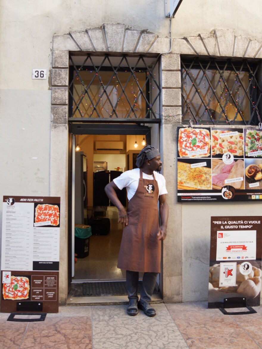 Ibrahim standing in front of his restaurant 