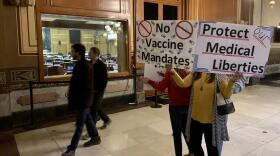 A group of Hoosiers rallied outside the empty House chamber after lawmakers canceled plans for a one-day session to pass a bill that effectively bans employers from enforcing COVID-19 vaccine mandates.