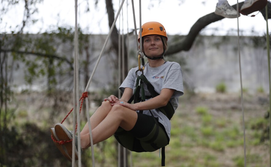 Festival attendees participate in tree climbing during the 2022 Publix Tampa Bay Collard Festival in St. Petersburg, Florida, on Saturday, February 19, 2022. Photo by Octavio Jones for WUSF