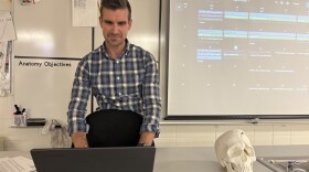 A man types on a laptop.