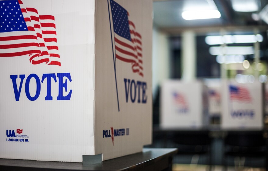 Photo of voting booths at U.S. polling station. [Moab Republic/Shutterstock]