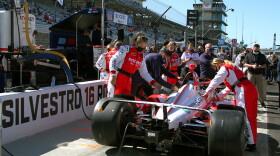 Paretta crew members prepare the team's car for the 105th running of the Indianapolis 500.