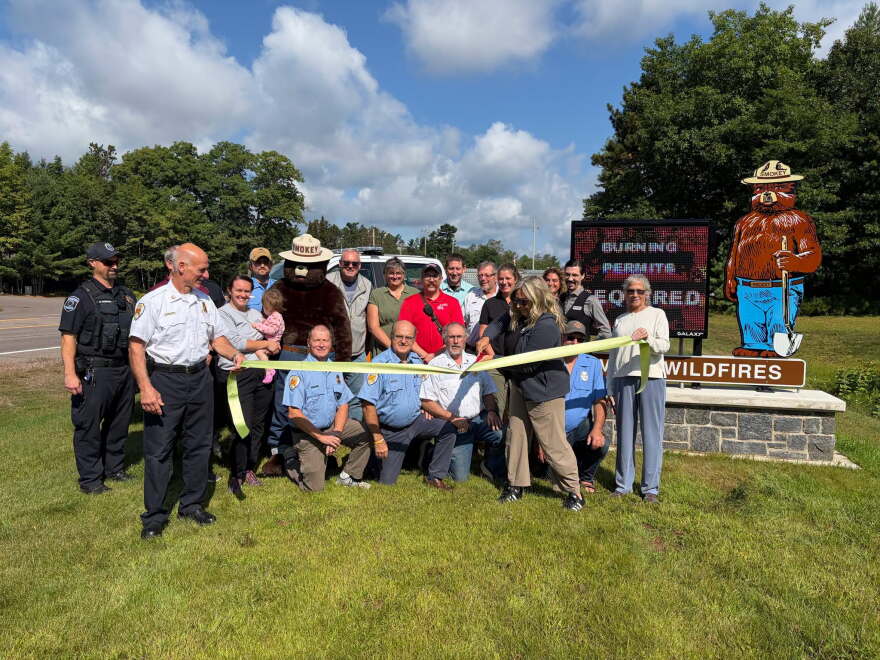 Ribbon cutting for the new electronic Smokey fire danger sign in Minocqua