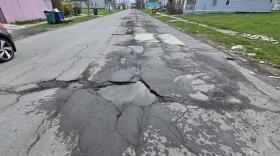 Many Buffalo streets like Goodyear Avenue (pictured) are riddled with potholes and temporary cold patch fixes.