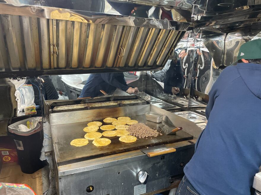 Chef Noel prepares beef tacos at Mr. Taco, a food truck operating on Water Street in downtown Milwaukee.