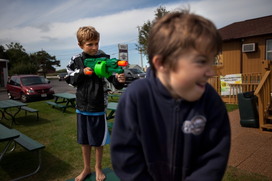 Wendt's grandchildren, Zach, 9, and Sawyer, 6, play with Nerf guns outside the family restaurant.