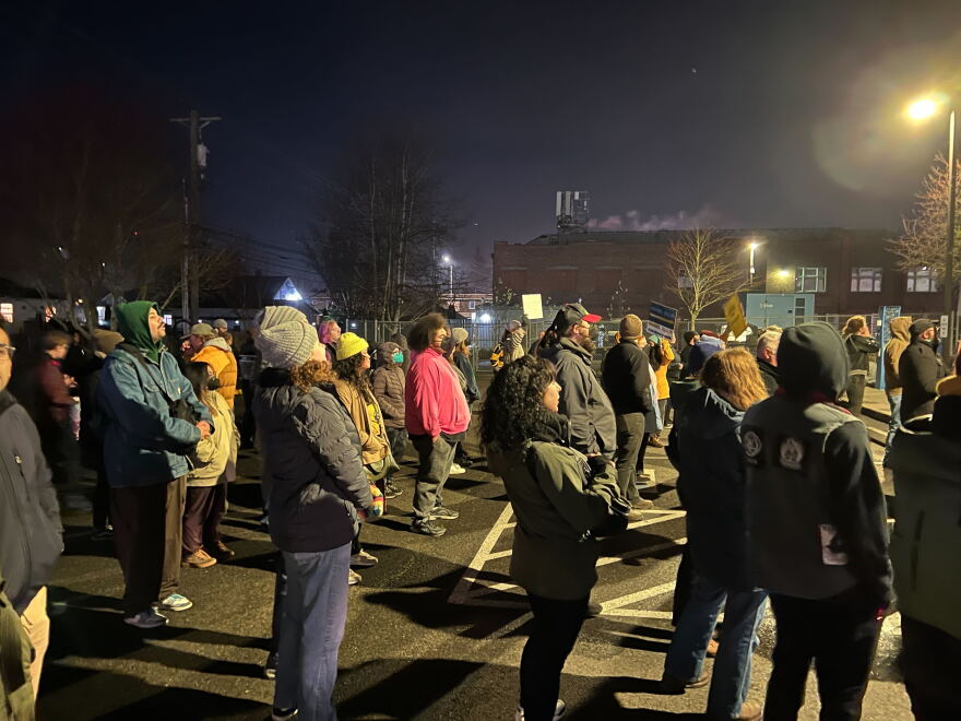 Protesters held a vigil in front of the mural, then marched to a nearby police precinct and stood for six minutes of silence.