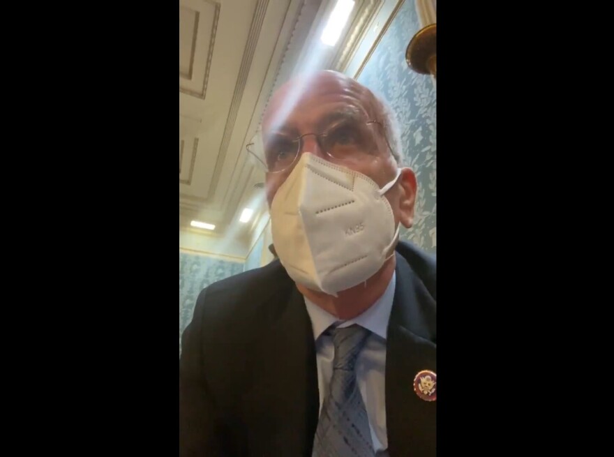 A masked Rep. Peter Welch speaks in a selfie video from the House Chamber