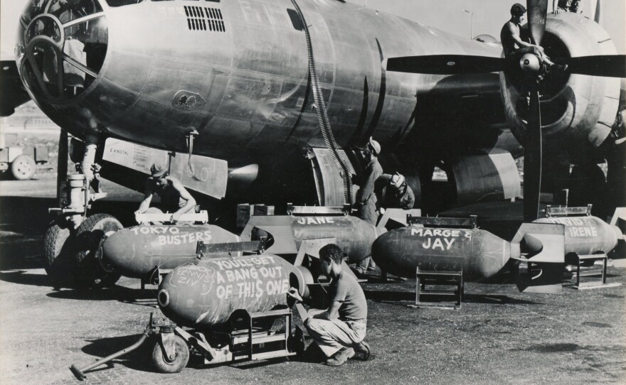 Ground crews on Saipan load ammunition and 2,000-pound bombs, adding a few personal notes to the weapons.