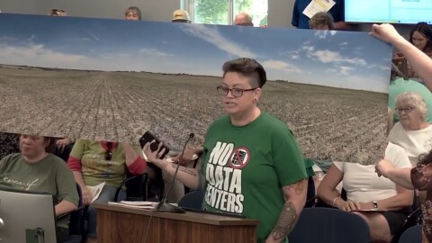 Clinton resident Allie Burke is showing the Clinton City Council the view from her house, where a proposed data center could be built. The council voted down a moratorium during its regular meeting on June 9th.