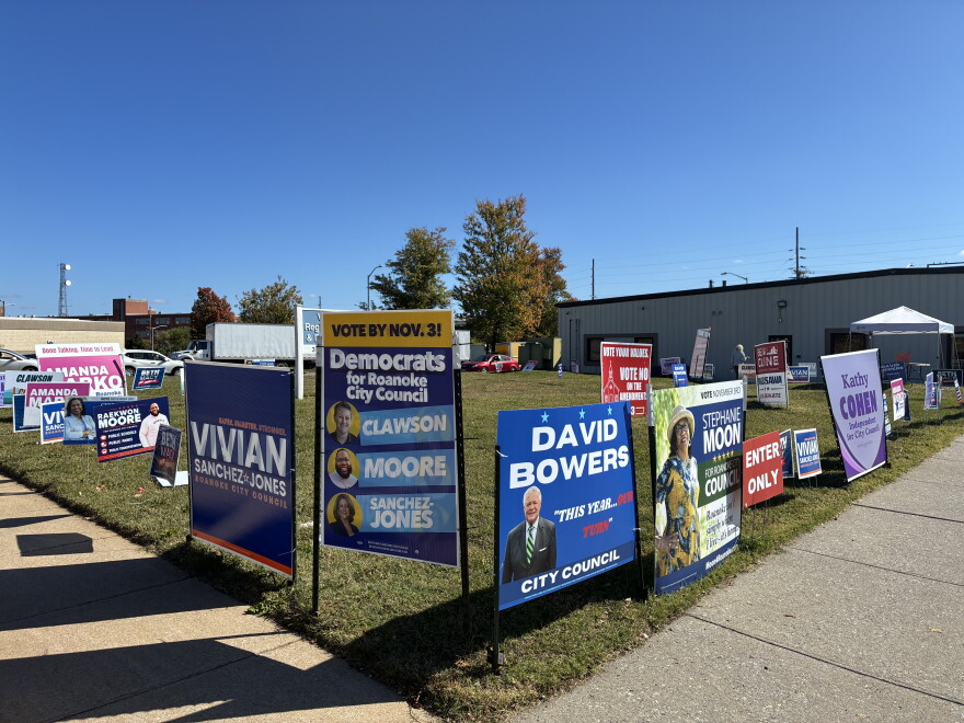 Signs adorn a street corner outside Roanoke's early voting site ahead of the 2026 election.