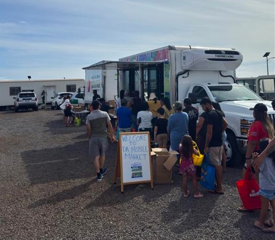 Maui residents line up for Maui Food Bank's mobile food distribution.