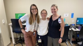 Three women: Dr. Lauryn Roth, Dr. Aubrey Armento, and sports nutritionist Amanda McCarthy, smile for a photo in their clinic. They are part of the new Female Athlete Program at Children's Hospital Colorado