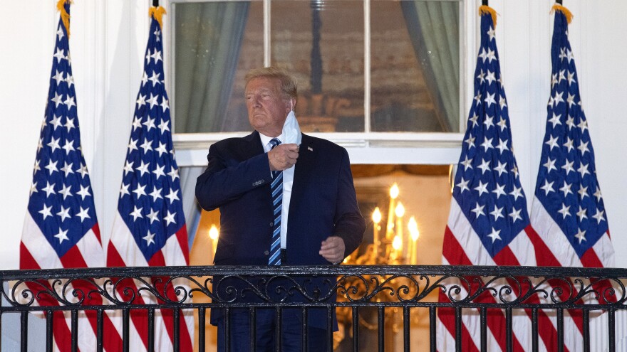 President Trump is seen removing his mask upon his return to the White House from Walter Reed National Military Medical Center on Monday, days after he tested positive for the coronavirus.