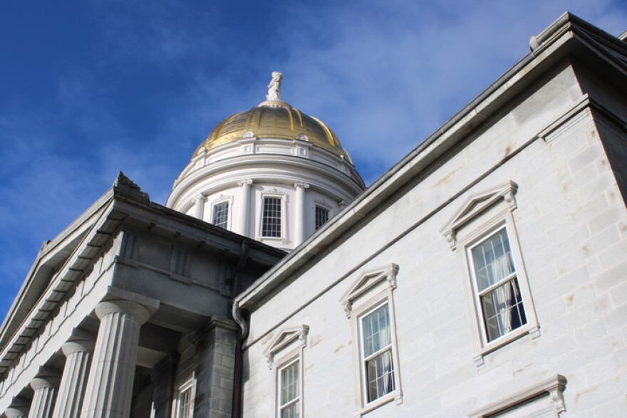 The gold dome of the Montpelier statehouse in the middle of the day.