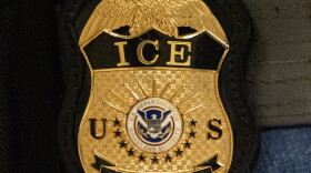 FILE - A federal agent wears an Immigration and Customs Enforcement badge in New York, June 10, 2025.