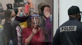 Pro-Trump protesters yell as they look through the windows of the central counting board as police were helping to keep others from entering due to overcrowding on Wednesday, Nov. 4, 2020, in Detroit. (Carlos Osorio/AP)
