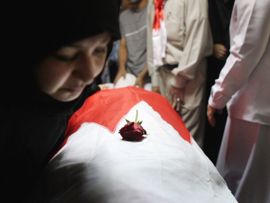 An independent commission found that the Bahrain security forces used excessive force and tortured some of those detained. Here, family members look upon the body of protester Abdul Ridha Mohammed, who was shot in the head and died of his wounds on Feb. 21, 2011.