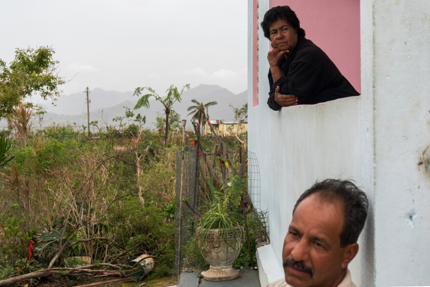 Jose Sanchez Acevedo, 52, and his mother, Cruz Acevedo Soler, 74, on the front porch of the Maricao farmhouse they live in. They told Mercy Corps they would purchase rice and beans if given $100.