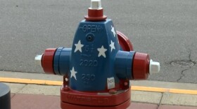 Fire hydrants in Antigo being given patriotic paint jobs