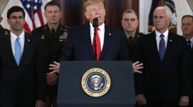 President Donald Trump addresses the nation from the White House on the ballistic missile strike that Iran launched against Iraqi air bases housing U.S. troops, Wednesday, Jan. 8, 2020, in Washington, as Vice President Mike Pence and others looks on. (Evan Vucci/AP)