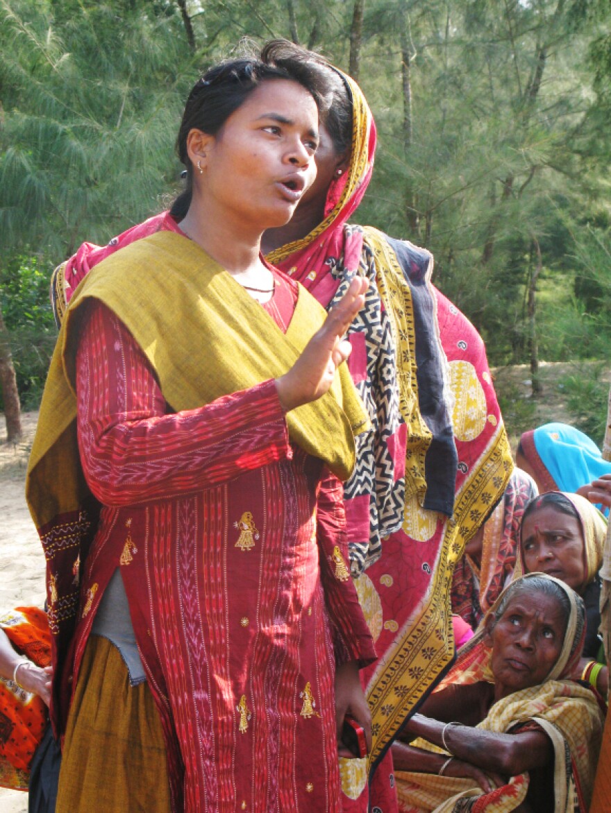 Activist Manorama Khatua speaks to a group of protesters on land that a steel company wants for a new mill in the southeastern state of Orissa, India, in October.