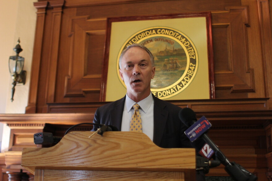 New Bedford Mayor Jon Mitchell gives a speech at a podium.
