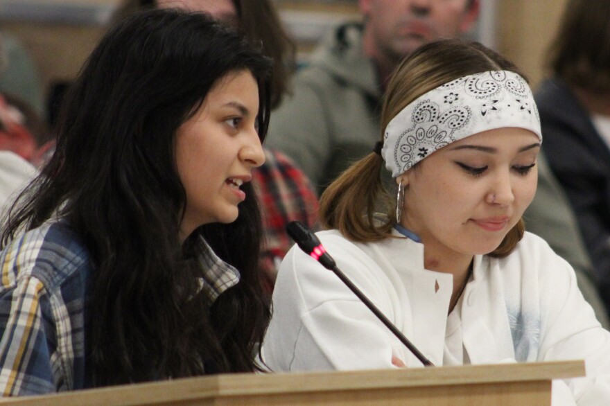 Stefany Montague (left) testifies in support of her school, Kenai Alternative High School, during a school board meeting on Monday, Apr. 8, 2025 in Soldotna, Alaska.