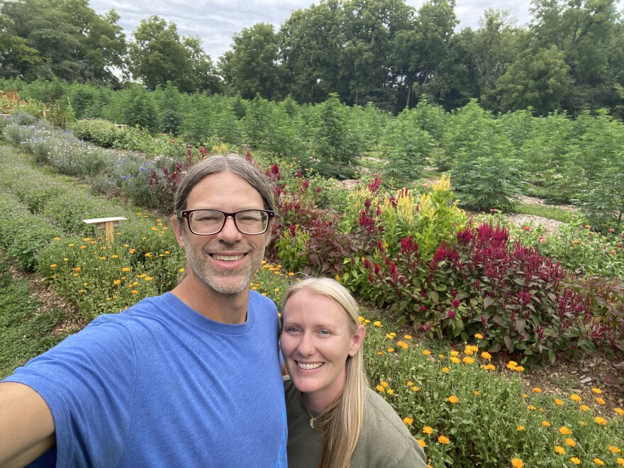 Scott and Megan Booker take a selfie on their farm in Homestead, Iowa. The couple co-own Four Winds Farm, where they grow organic hemp, flowers and herbs while also using biochar as a soil amendment.