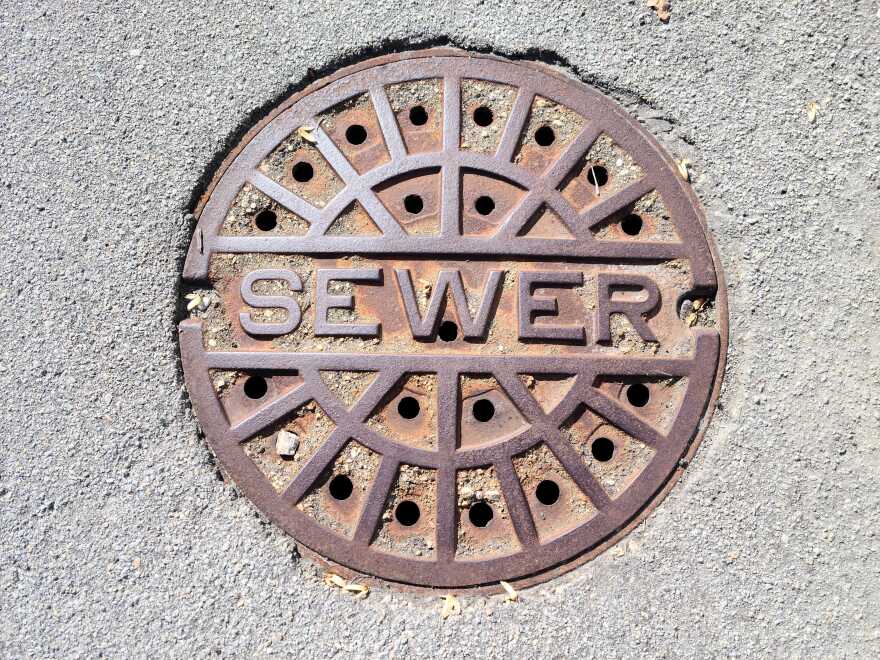 sewer cover that says sewer