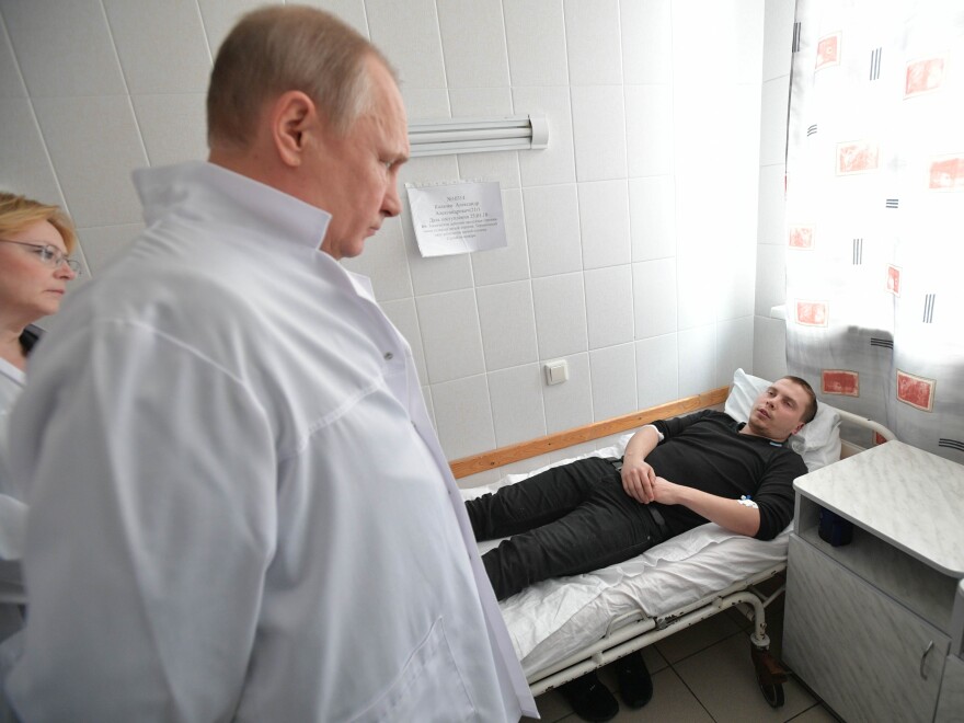 Putin visits a hospital to check on people injured in a fire that engulfed the Zimnyaya Vishnya shopping center in Kemerovo.